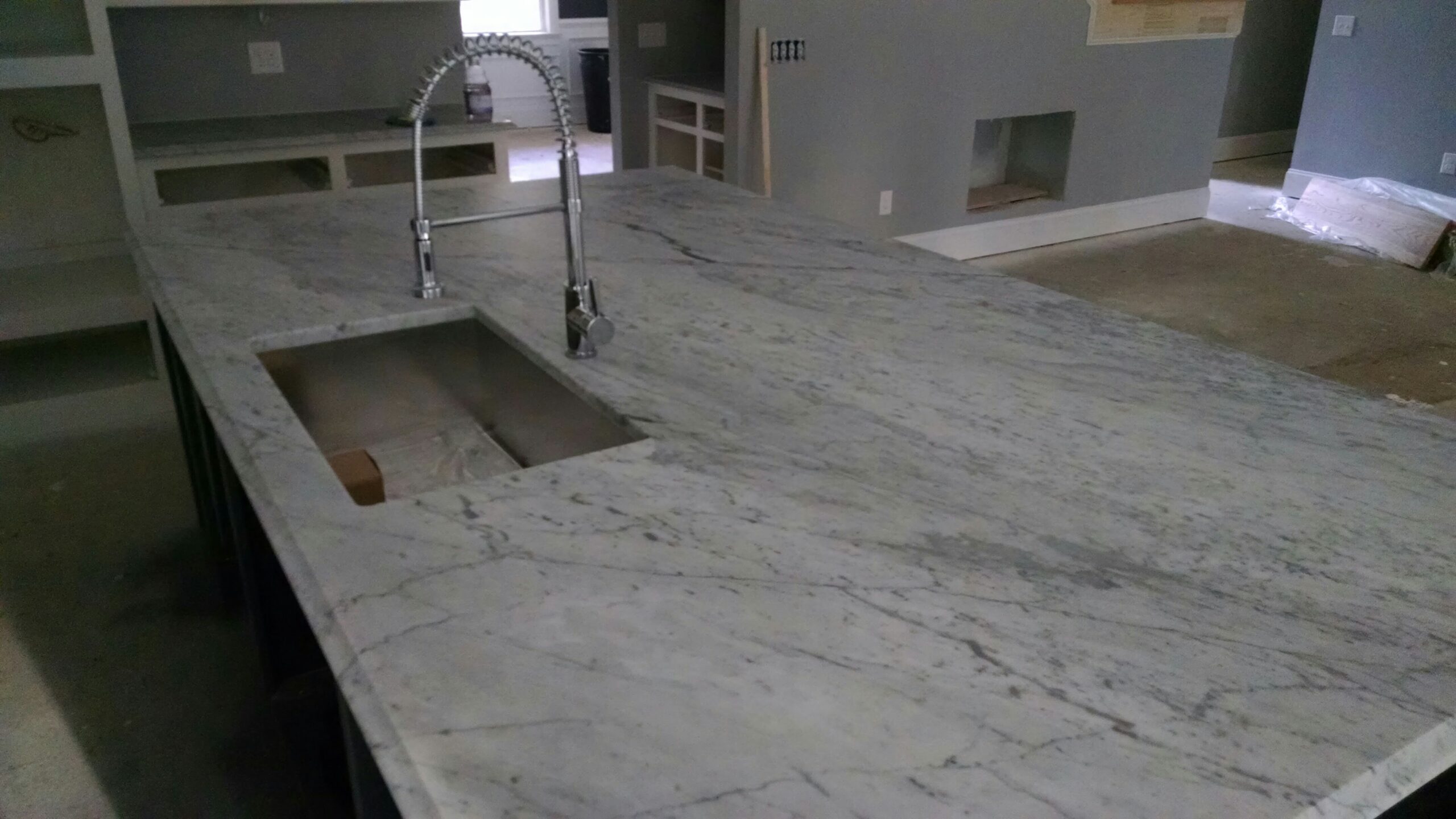 White granite countertop with soft grey veining in a kitchen