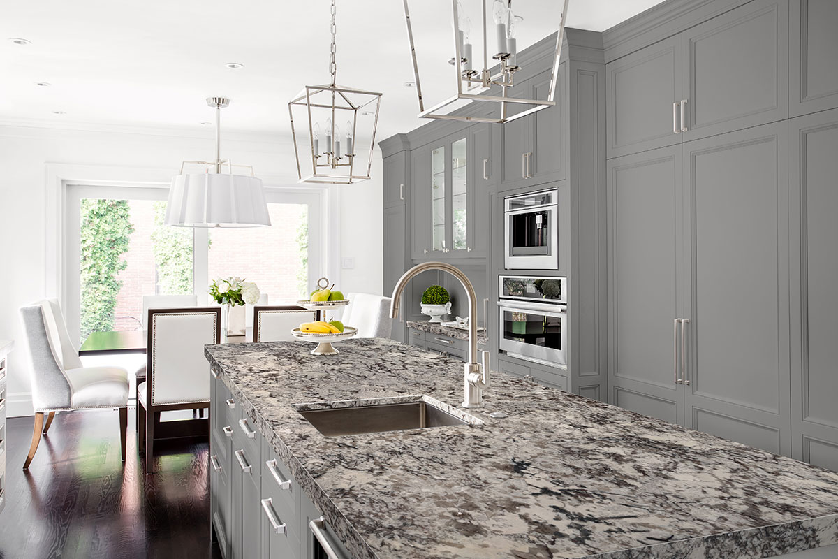 Delicatus White granite countertop against grey cabinetry, showing the natural flecking across the slab