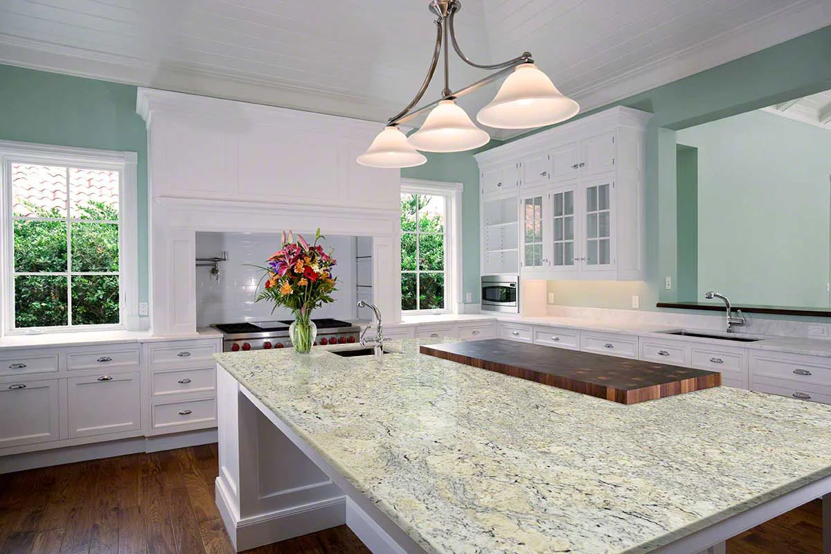 White Ice granite countertops installed in a bright kitchen with white cabinetry