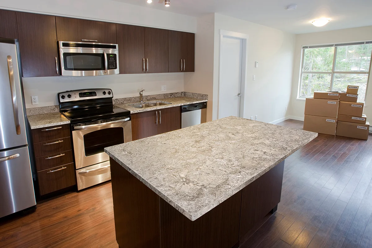 White Sand granite kitchen countertops in a warm neutral palette with timber cabinetry