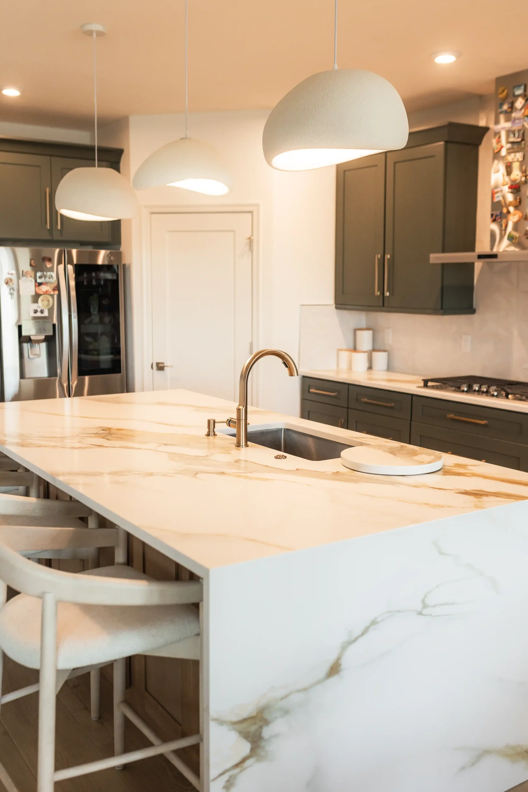 Deep green shaker cabinets with brushed handles in a finished Columbus kitchen